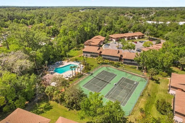 an aerial view of a house with a yard