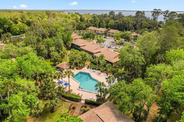 an aerial view of a house with a yard