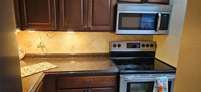 a stove top oven sitting inside of a kitchen