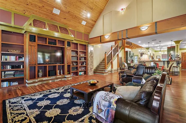 a living room with furniture and a floor to ceiling window