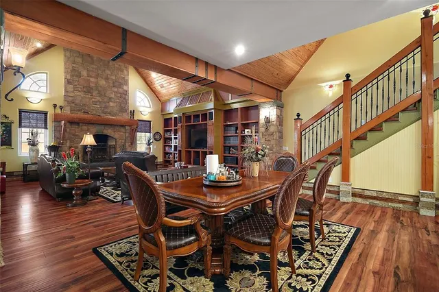 a dining room with furniture window and wooden floor