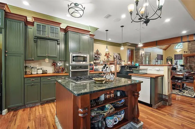 a kitchen with stainless steel appliances granite countertop a stove and a refrigerator