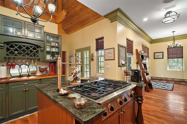 a bathroom with a granite countertop sink a mirror and shower