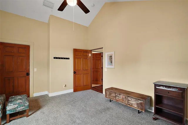 a living room with furniture and a ceiling fan