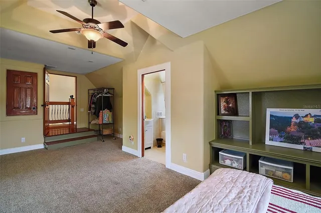 a view of a patio with table and chairs and couches with wooden floor and fence