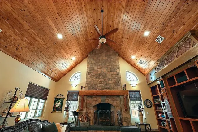 a living room with fireplace furniture and a flat screen tv