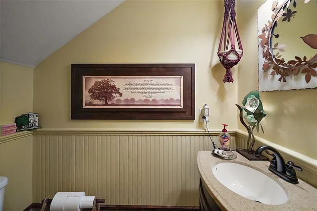 a bathroom with a sink mirror and vanity