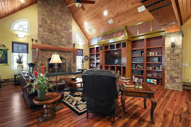 a living room with furniture and a book shelf