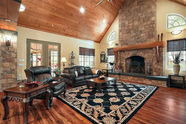 a living room with furniture rug and a fireplace