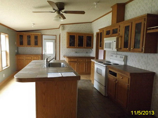 1270 Lick Ridge Road Northeast Check, VA 24072 - Photo 7 of 11 a kitchen with stainless steel appliances granite countertop a sink dishwasher a stove and a refrigerator with wooden floor