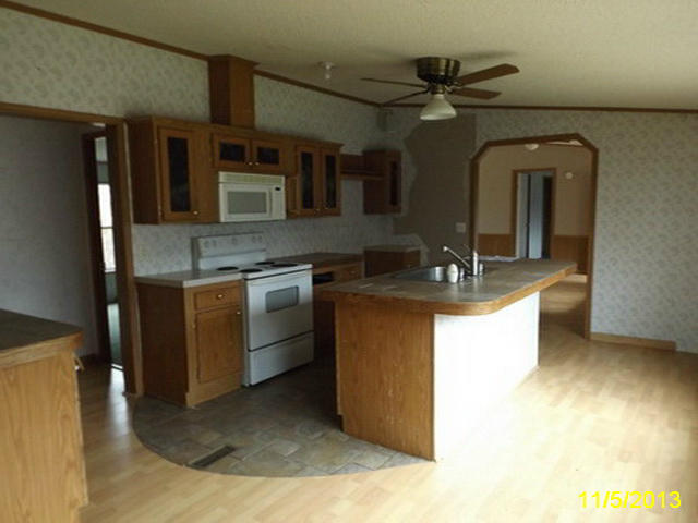 1270 Lick Ridge Road Northeast Check, VA 24072 - Photo 8 of 11 a kitchen with stainless steel appliances granite countertop a sink a stove and a refrigerator