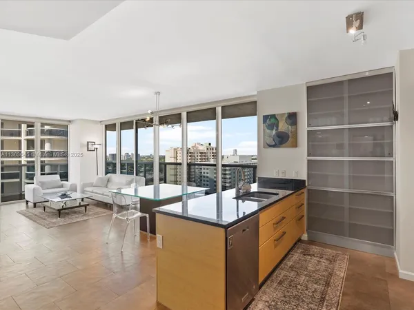 a very nice looking living room with a large window and a dining table with garden view