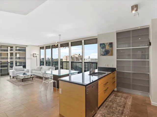 a very nice looking living room with a large window and a dining table with garden view