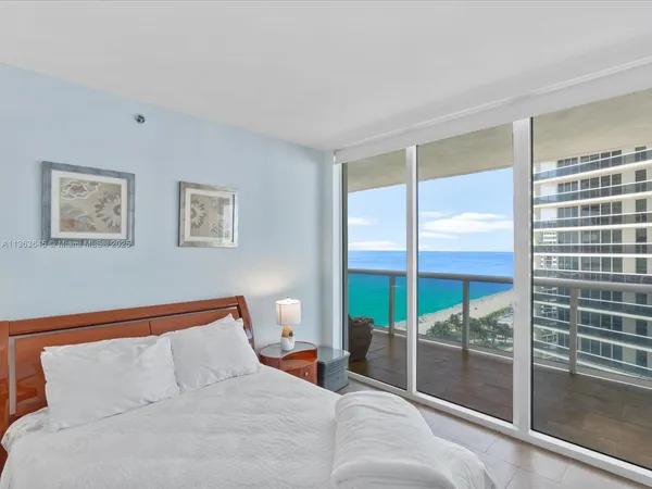 a bedroom with a large bed and a large window