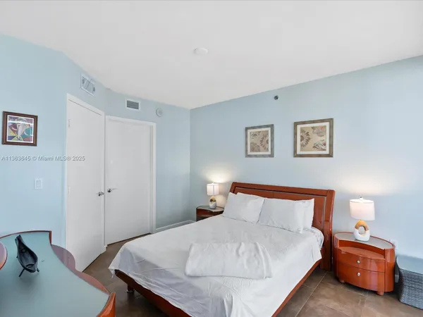 a bedroom with a bed and a furniture