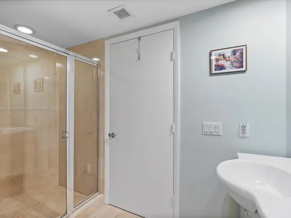 a bathroom with a shower a toilet and sink