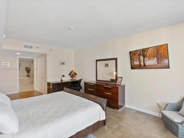 a bed room with a bed and a chair