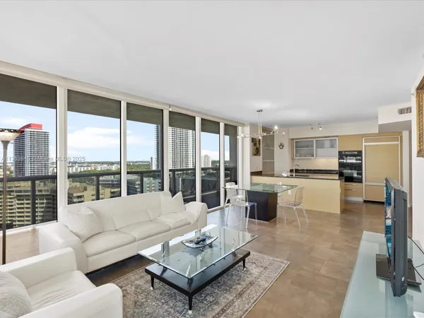 a living room with furniture and a large window