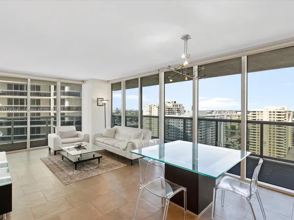 a living room with furniture and large windows