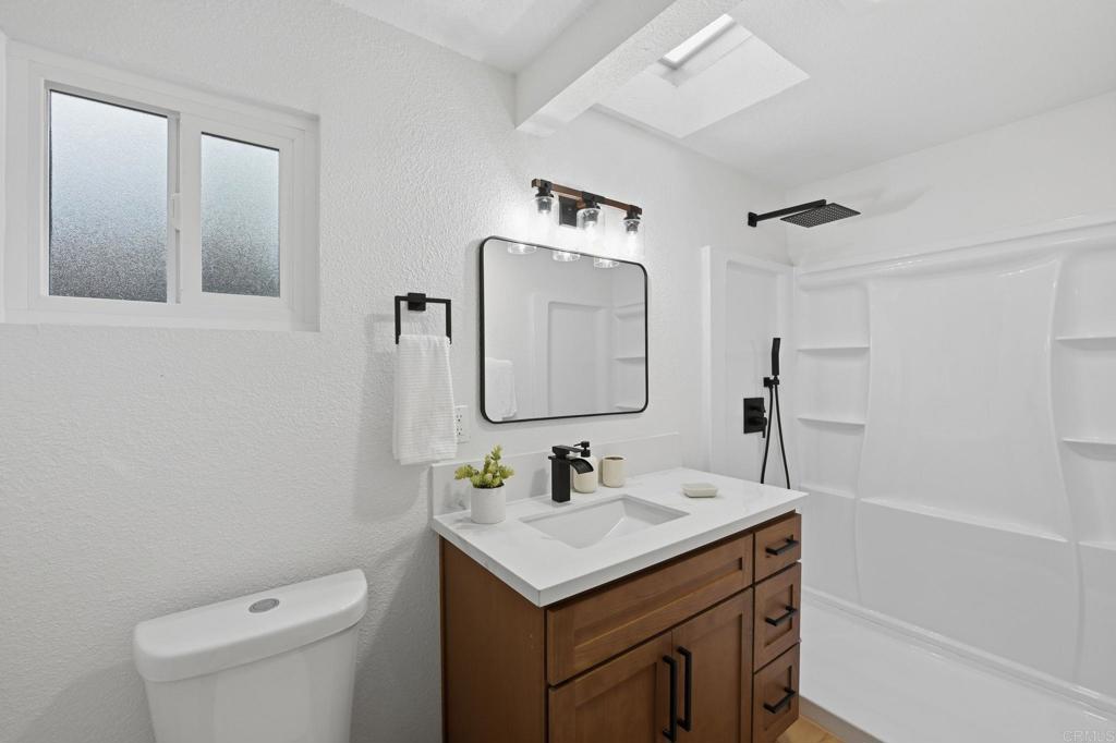 1333 Helix Street Spring Valley, CA 91977 - Photo 29 of 45 a bathroom with a sink toilet and mirror