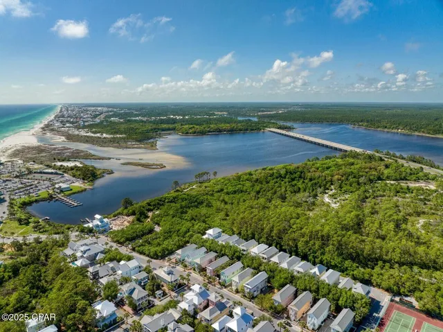 a kitchen with stainless steel appliances granite countertop a stove top oven a sink dishwasher a refrigerator and a microwave oven with wooden cabinets