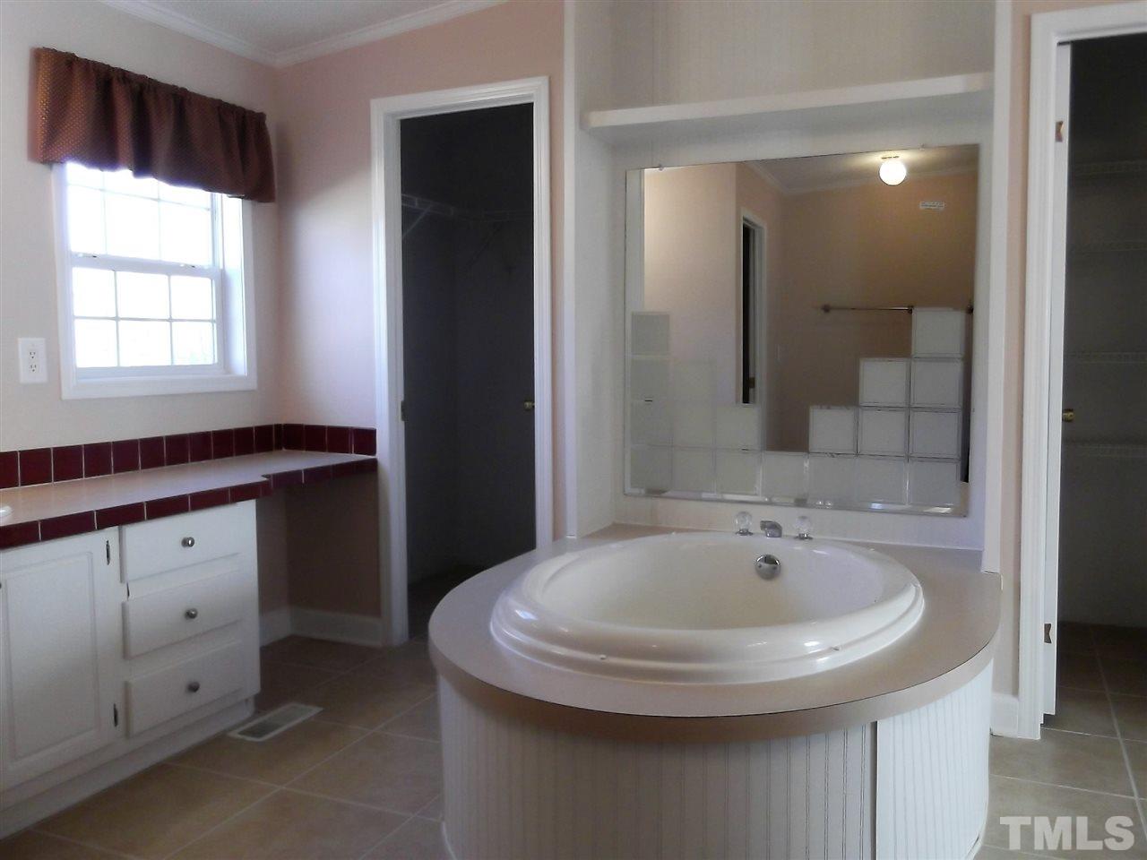 1060 Wrenn Crumpton Road Roxboro, NC 27574 - Photo 13 of 21 a bathroom with a sink and a mirror
