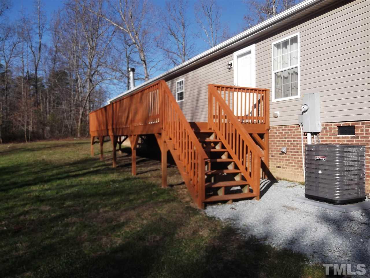 1060 Wrenn Crumpton Road Roxboro, NC 27574 - Photo 3 of 21 a view of a back yard with chairs