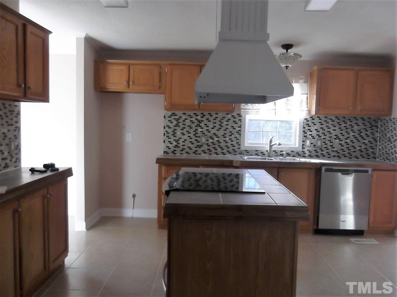 1060 Wrenn Crumpton Road Roxboro, NC 27574 - Photo 7 of 21 a kitchen with a stove and a refrigerator
