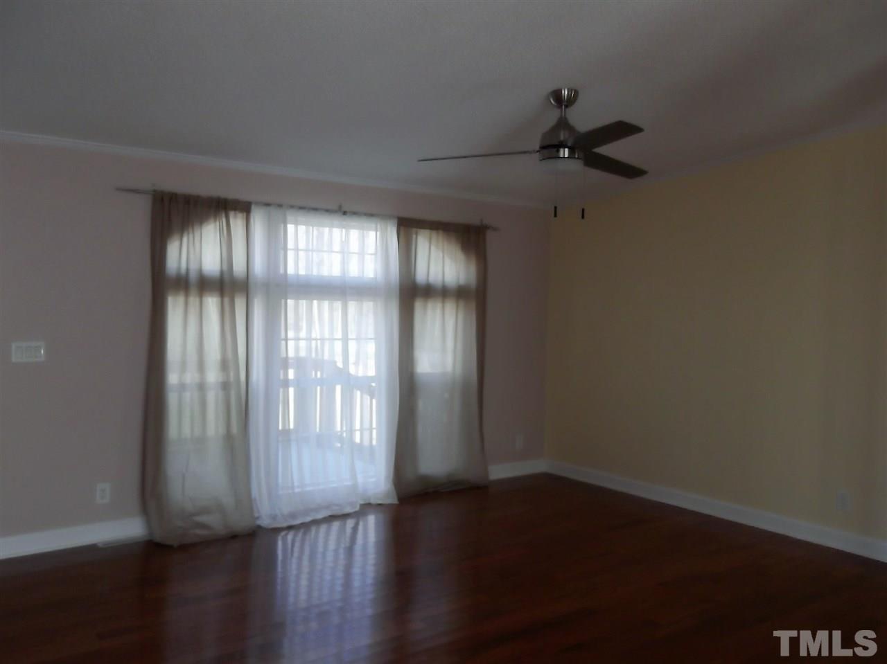 1060 Wrenn Crumpton Road Roxboro, NC 27574 - Photo 9 of 21 a view of an empty room with wooden floor and a window