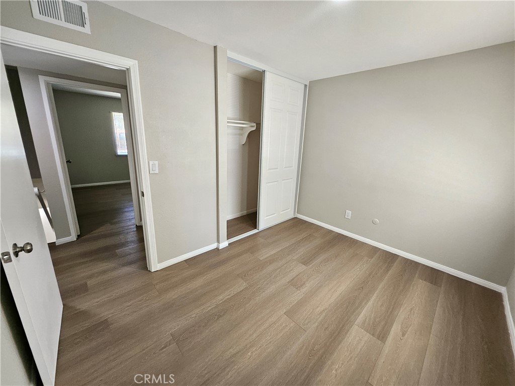 1151 Clark Street Riverside, CA 92501 - Photo 13 of 24 an empty room with wooden floor and entrance