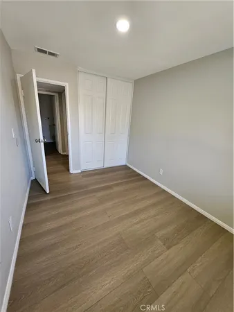 a view of hallway with wooden floor