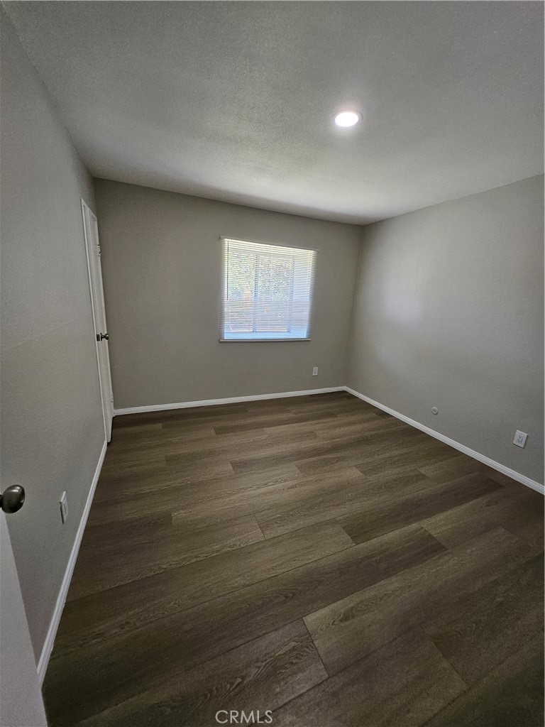 1151 Clark Street Riverside, CA 92501 - Photo 9 of 21 an empty room with wooden floor and windows