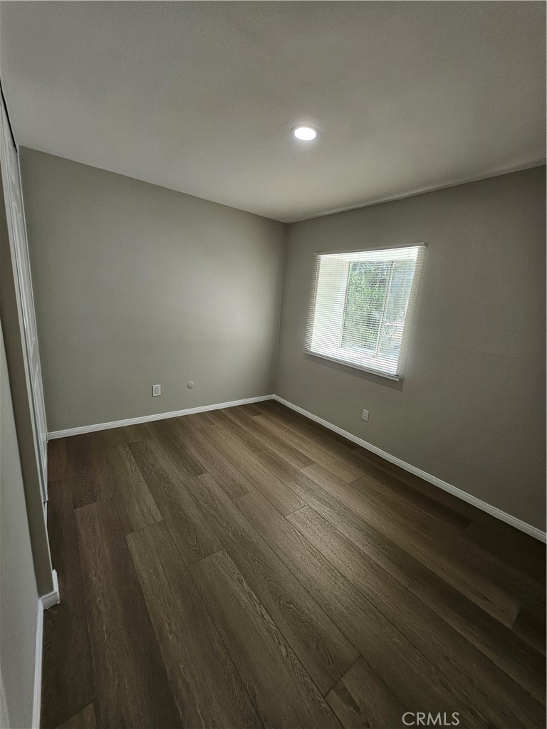 1151 Clark Street Riverside, CA 92501 - Photo 10 of 21 an empty room with wooden floor and windows