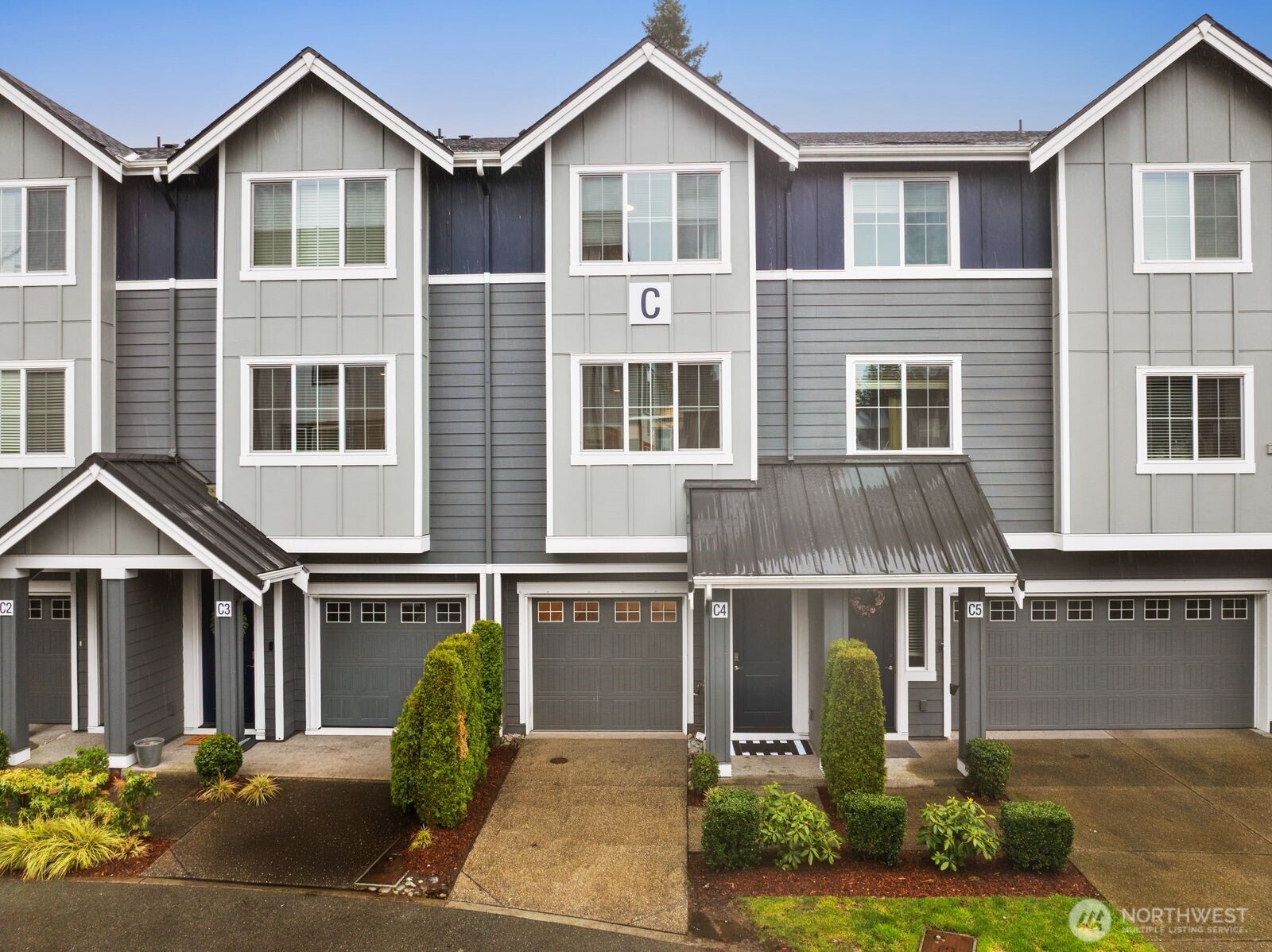 1621 Seattle Hill Road, Unit C4 Bothell, WA 98012 - Photo 27 of 35 a front view of a house with a yard and garage