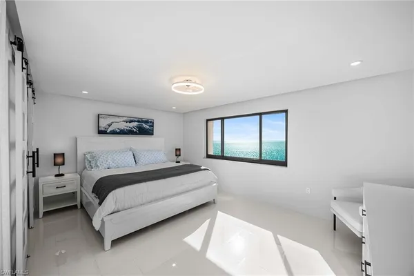 a spacious bedroom with a bed and a window