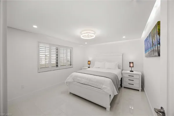 a bed room with a bed and a window