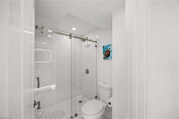 a bathroom with a shower a toilet and sink