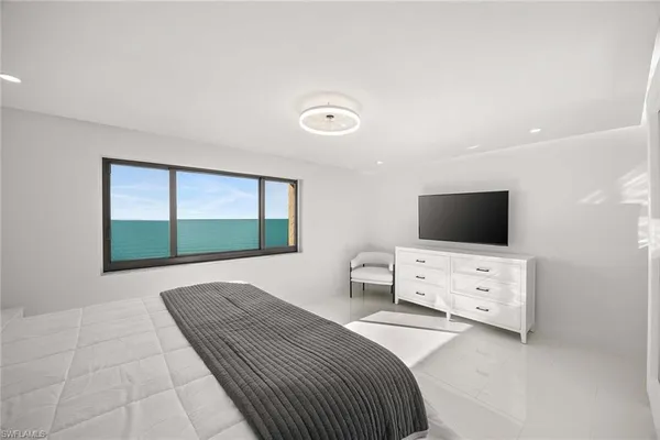 a bedroom with a bed and a television