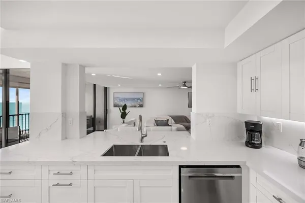 a kitchen with a sink and white cabinets