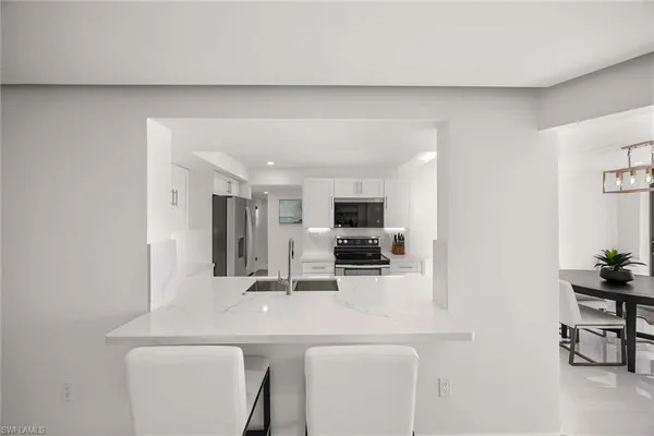 a kitchen with a sink a stove and a refrigerator