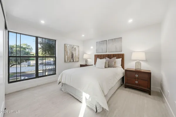 a bedroom with a large bed and a couch