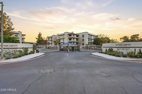a front view of a building with entryway and outdoor seating