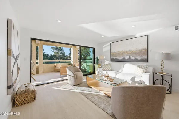 a living room with furniture and a large window