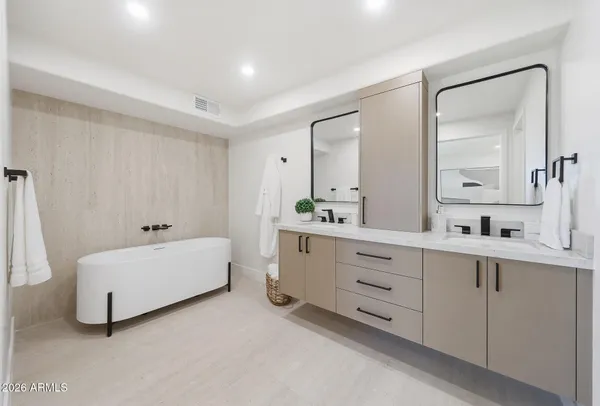a kitchen with stainless steel appliances kitchen island granite countertop a sink and a refrigerator