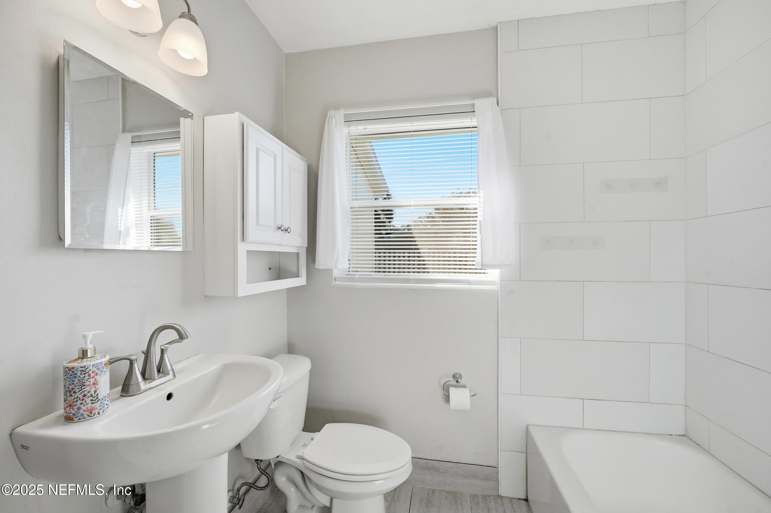 6500 Altama Road Jacksonville, FL 32216 - Photo 16 of 30 a bathroom with a sink a toilet and shower