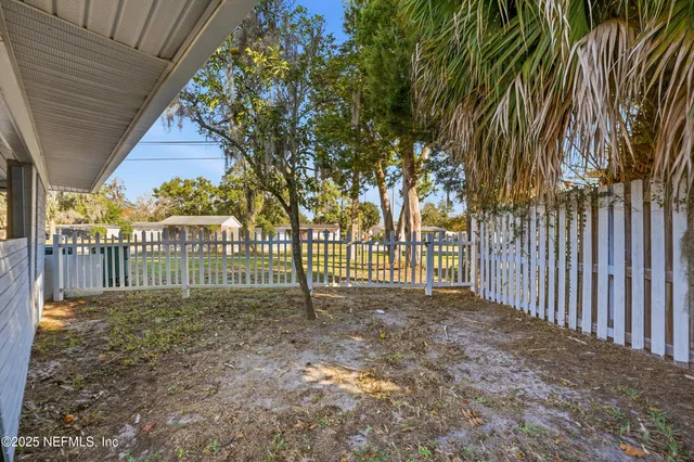 a view of a backyard with a small cabin and a chair