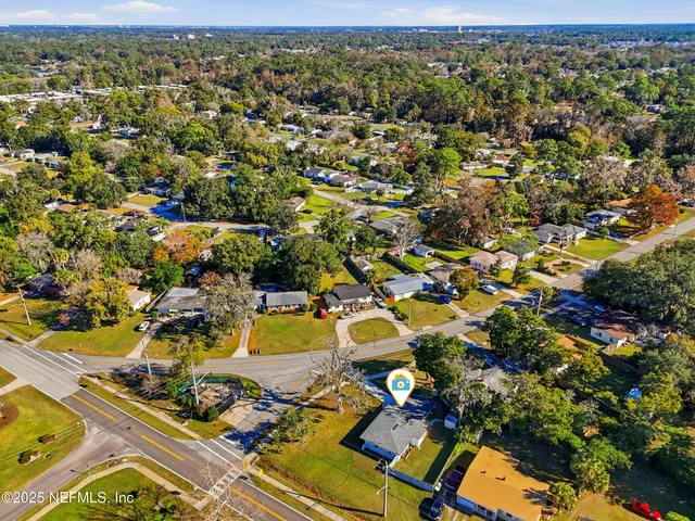 an aerial view of residential houses with outdoor space