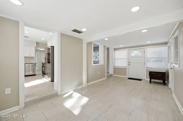 a view of a livingroom with a fireplace and window