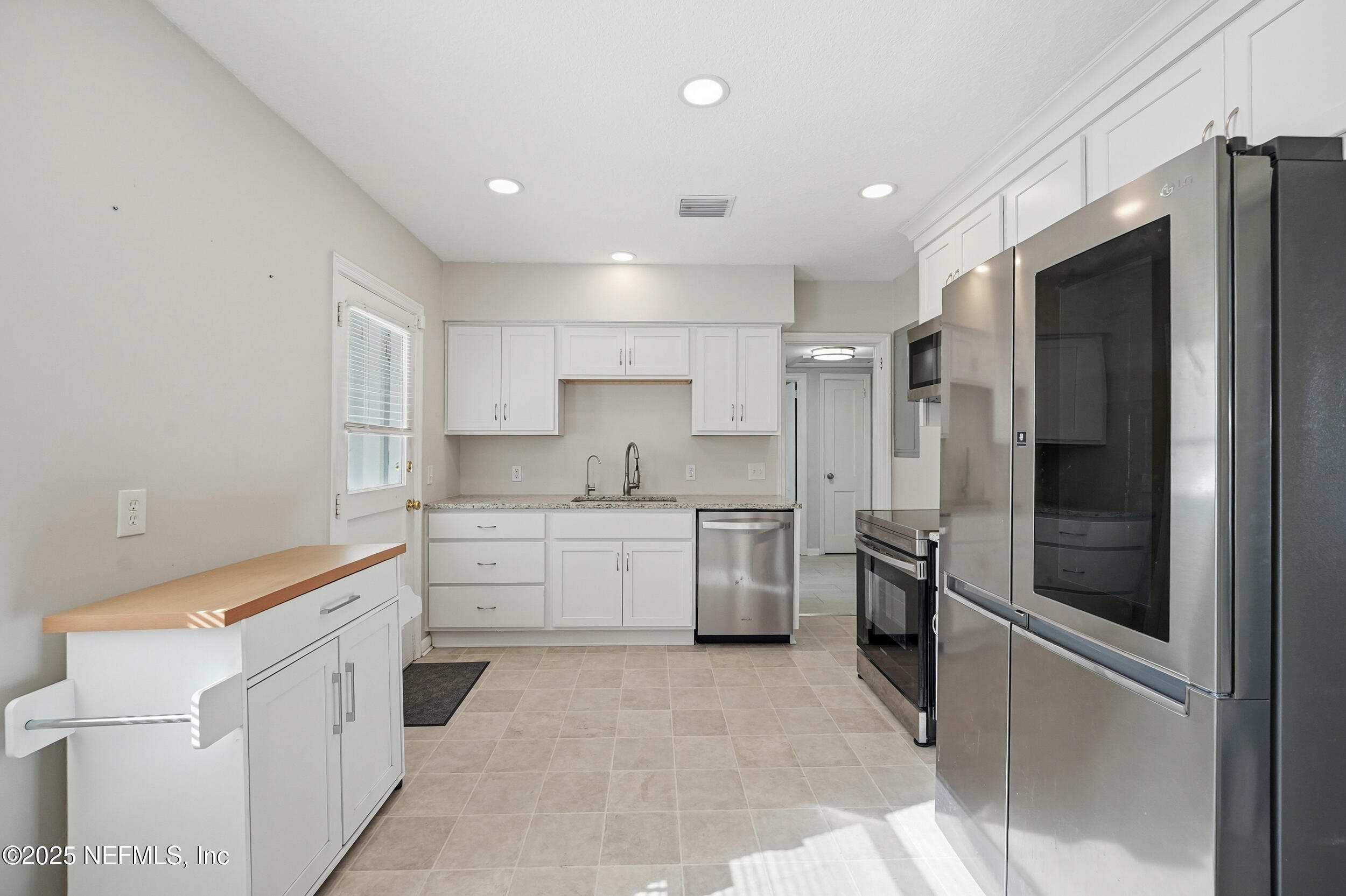 6500 Altama Road Jacksonville, FL 32216 - Photo 8 of 30 a kitchen with a refrigerator sink and cabinets