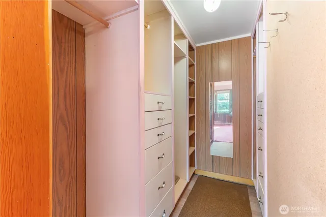 a view of walk in closet with white walls
